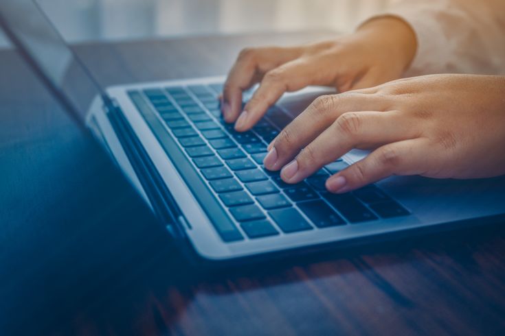 a man signing up for a timeshare on a computer