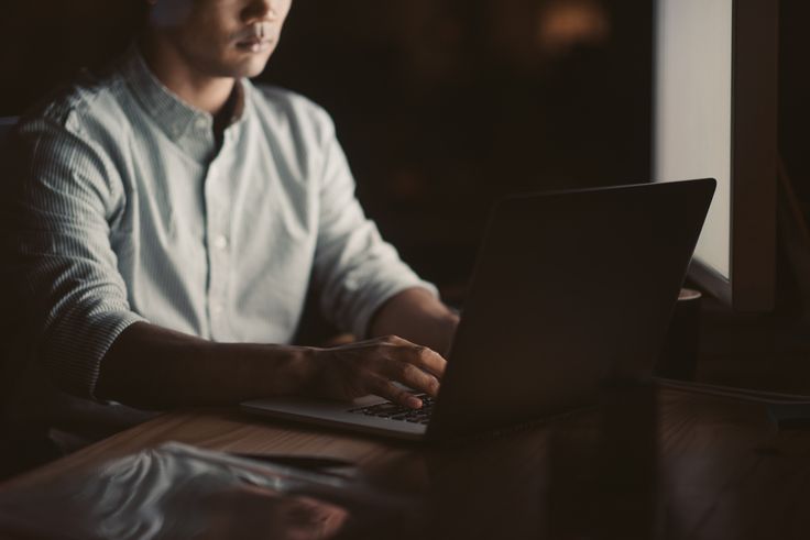 a man using a computer and falling victim to purchase scams